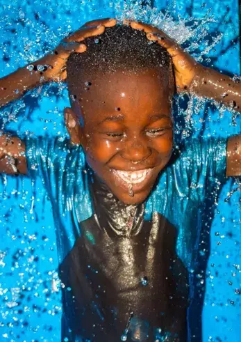 Joyful Child Enjoying Fresh Clean Water Nigeria